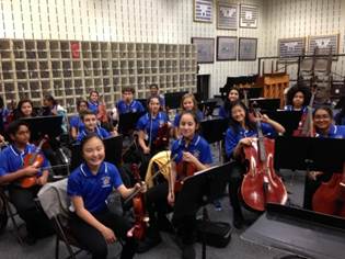 A group of people sitting in front of a building

Description generated with very high confidence